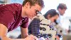 microbiology student conducting lab work with microscope